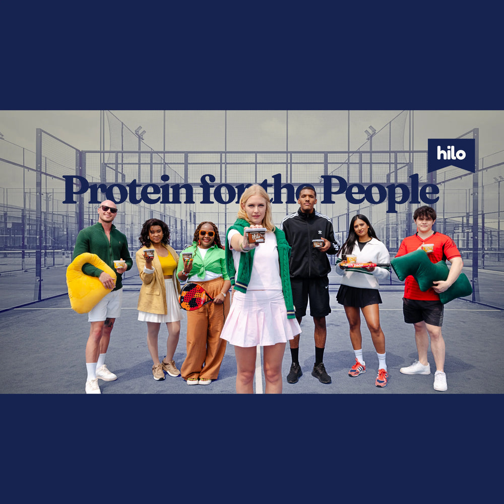 Group of people holding Hilo Protein Pudding with 'Protein for the People' and 'hilo' branding on a sports court.